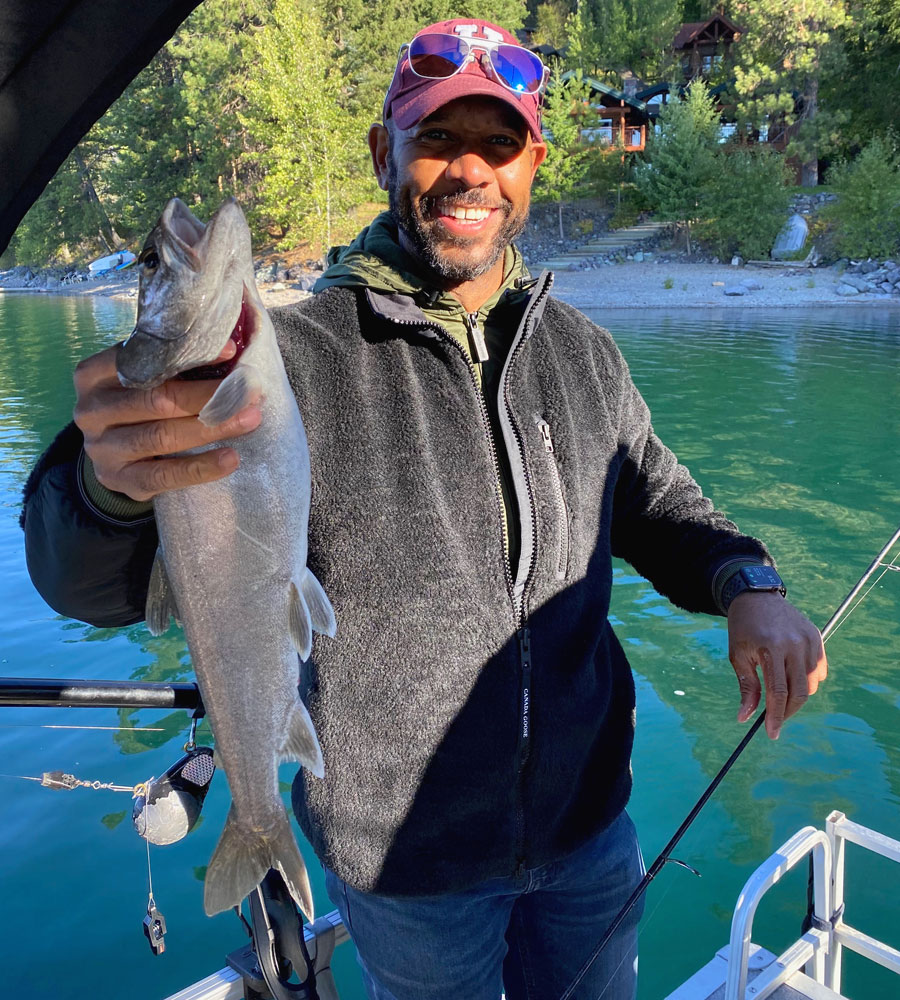 Ather Williams III holds up his big catch of the day from a fishing trip last year with his son and father.