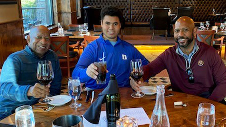 Ather Williams III, his son Ather IV, and father Ather Jr. share a toast while dining together.