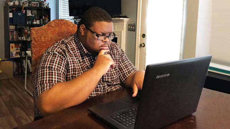 David Miller sitting and working on a laptop