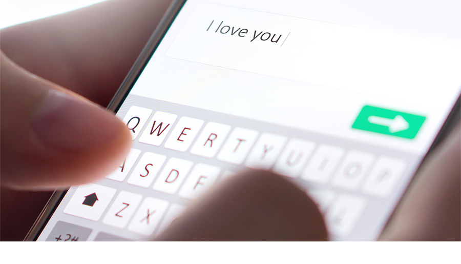 An image of a cell phone shows someone typing the text "I love you"