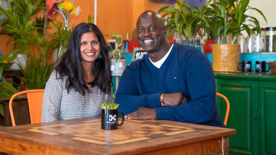 A man and woman sit at a table in a café.