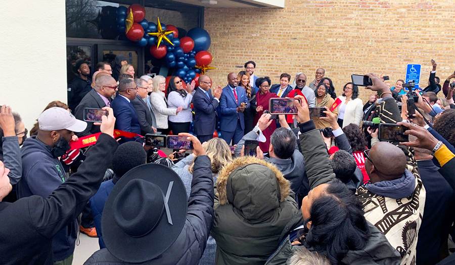 A crowd is gathered around the new First Independence Bank branch in Minneapolis.