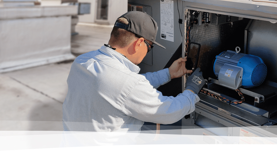 A person installs a piece of equipment.